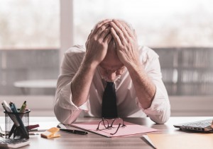 Stressed businessman sitting in office